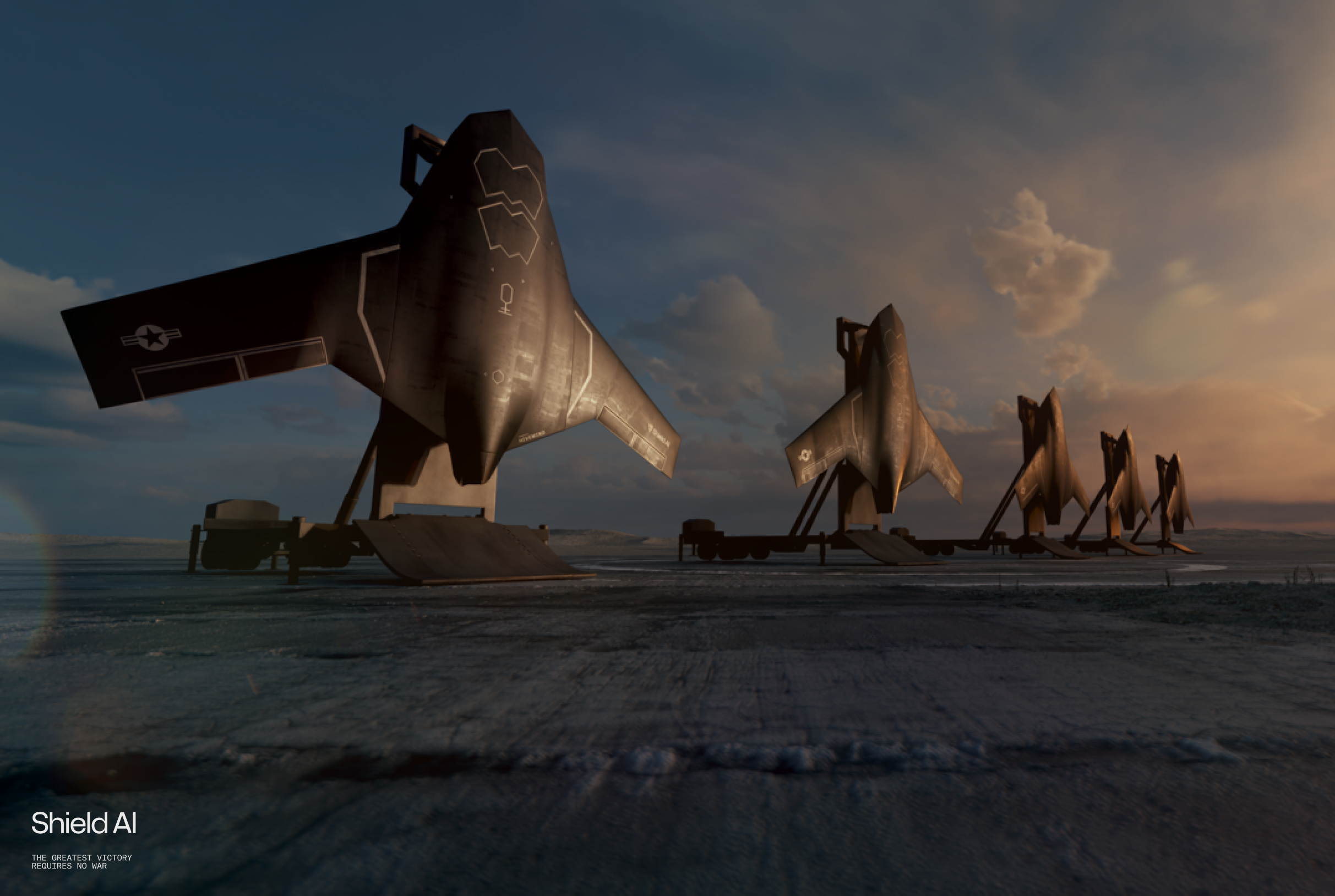 X-BAT-Shield-AI – Tumisang Bogwasi Line of Shield AI X-Bat VTOL aircraft mounted on mobile launch platforms, positioned in a desert at sunrise.