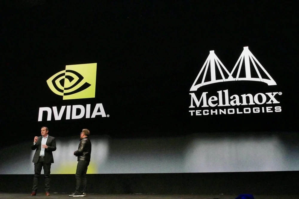 Mellanox technologies – Tumisang Bogwasi wo executives on stage with Nvidia and Mellanox logos displayed on a large screen during an acquisition announcement event.