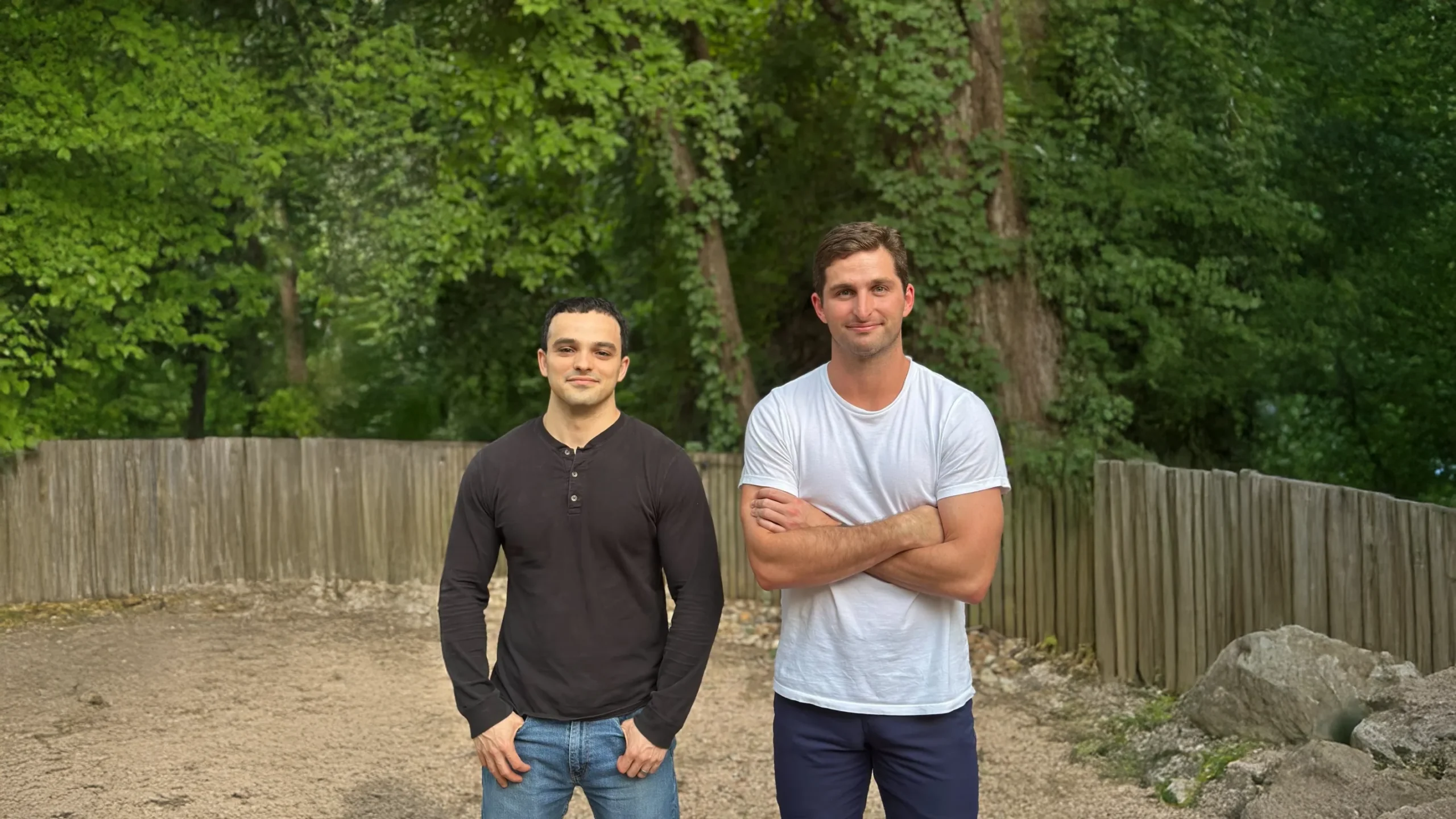Base Co-Founders Zach Dell and Justin Lopas – Tumisang Bogwasi Zach Dell and Justin Lopas, co-founders of Base, standing outdoors in a wooded area, facing the camera in casual attire with a relaxed, confident posture.