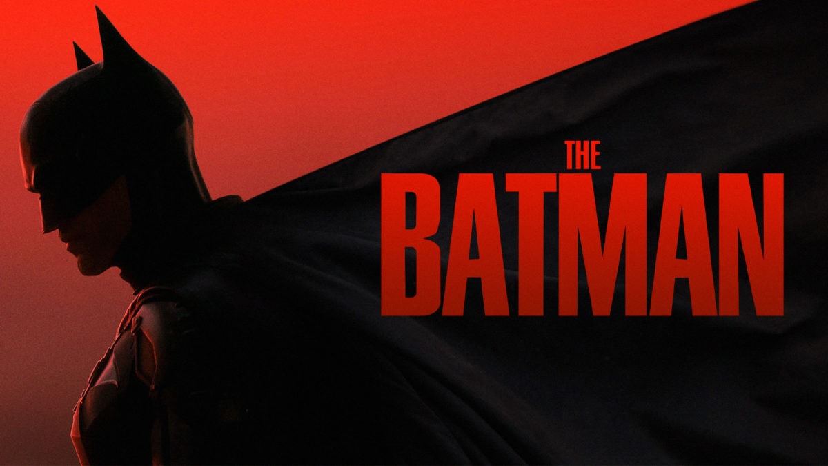 The Batman 2022 Dark Rebirth of Gothams Vigilante – Tumisang Bogwasi Silhouette of Batman against a red background with the title “The Batman” in bold red letters.