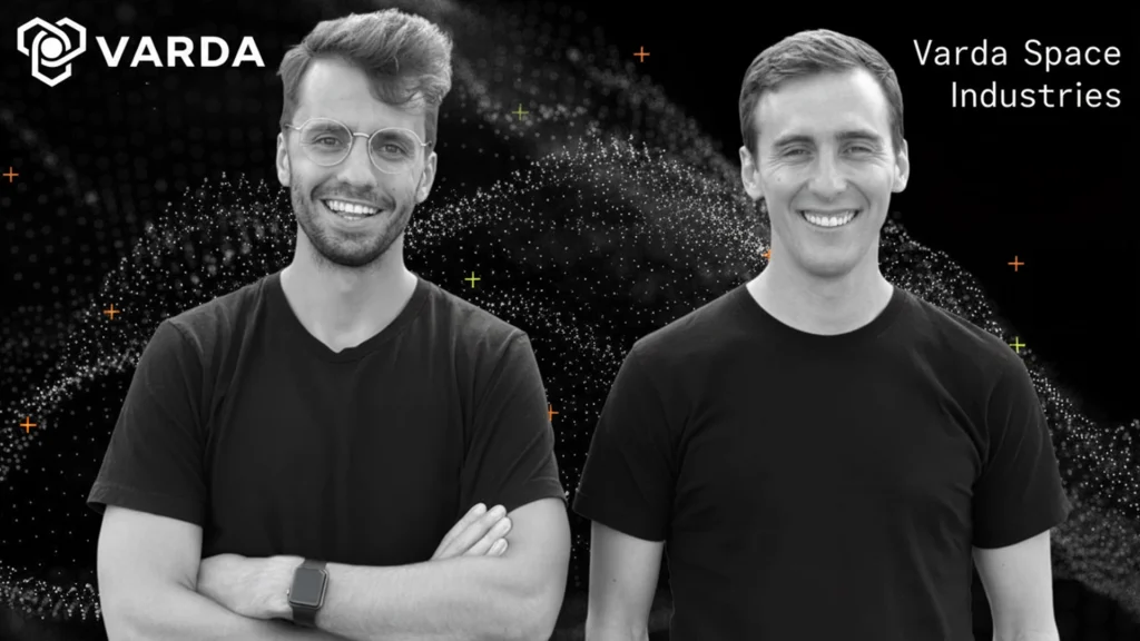 Black-and-white portrait of Delian Asparouhov and Will Bruey, co-founders of Varda Space Industries, standing side by side in front of a space-themed graphic background.