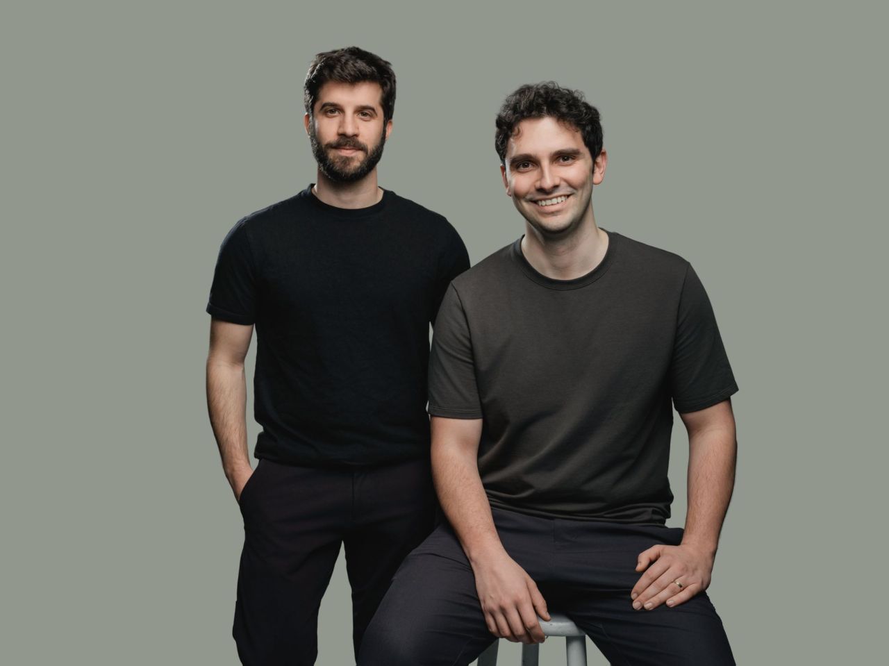 Eugen Alpeza and Yannis Karamanlakis, founders of EdraAI, standing and seated against a neutral background.