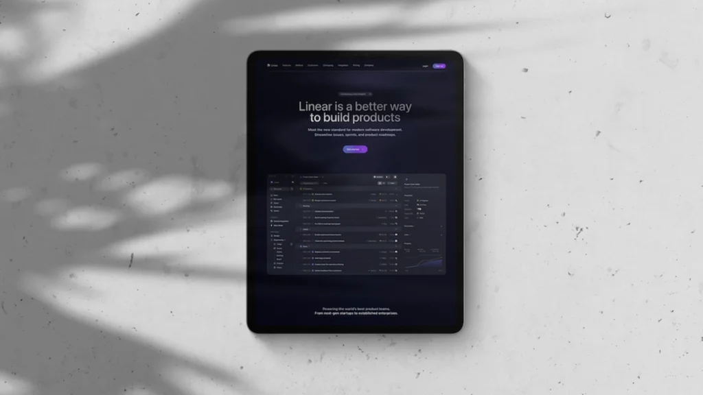 Tablet on a light surface displaying the Linear website with the headline “Linear is a better way to build products.”