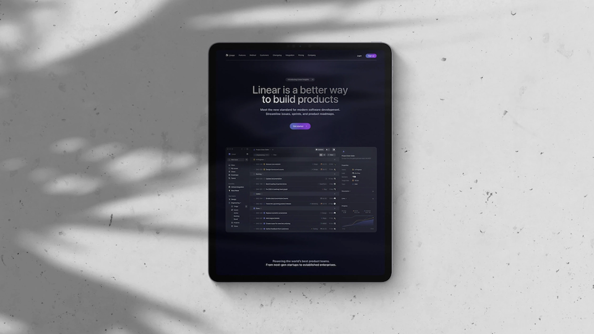 Tablet on a light surface displaying the Linear website with the headline “Linear is a better way to build products.”