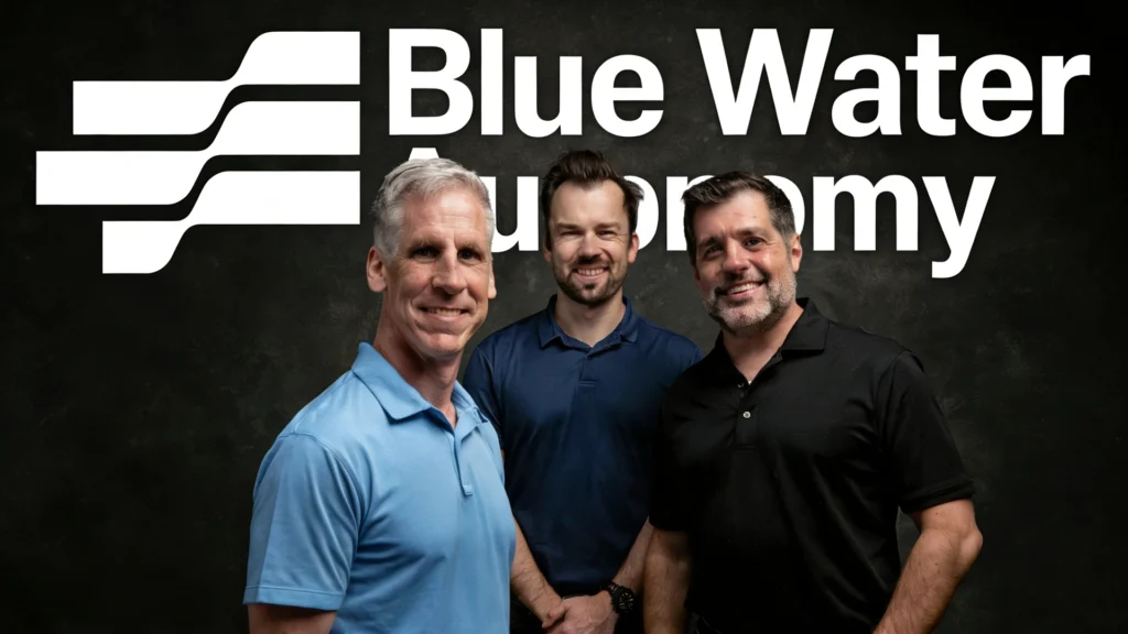 Blue Water Autonomy Founders Portrait – Tumisang Bogwasi Scott N. Miller, Austin Gray, and Rylan Hamilton standing together in front of the Blue Water Autonomy logo.