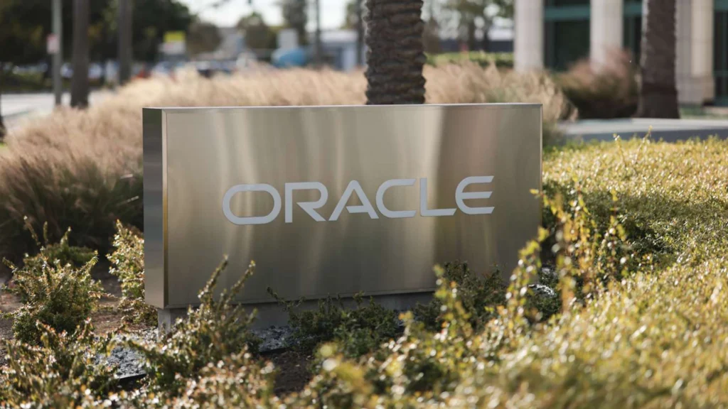 Oracle Headquarters Signage in Silicon Valley – Tumisang Bogwasi Oracle logo on a metallic sign outside a corporate office building surrounded by greenery.