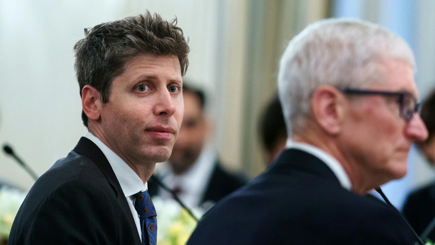 Sam Altman and Tim Cook at a High-Level Technology Discussion – Tumisang Bogwasi Sam Altman seated beside Apple CEO Tim Cook during a formal technology-related meeting or event.
