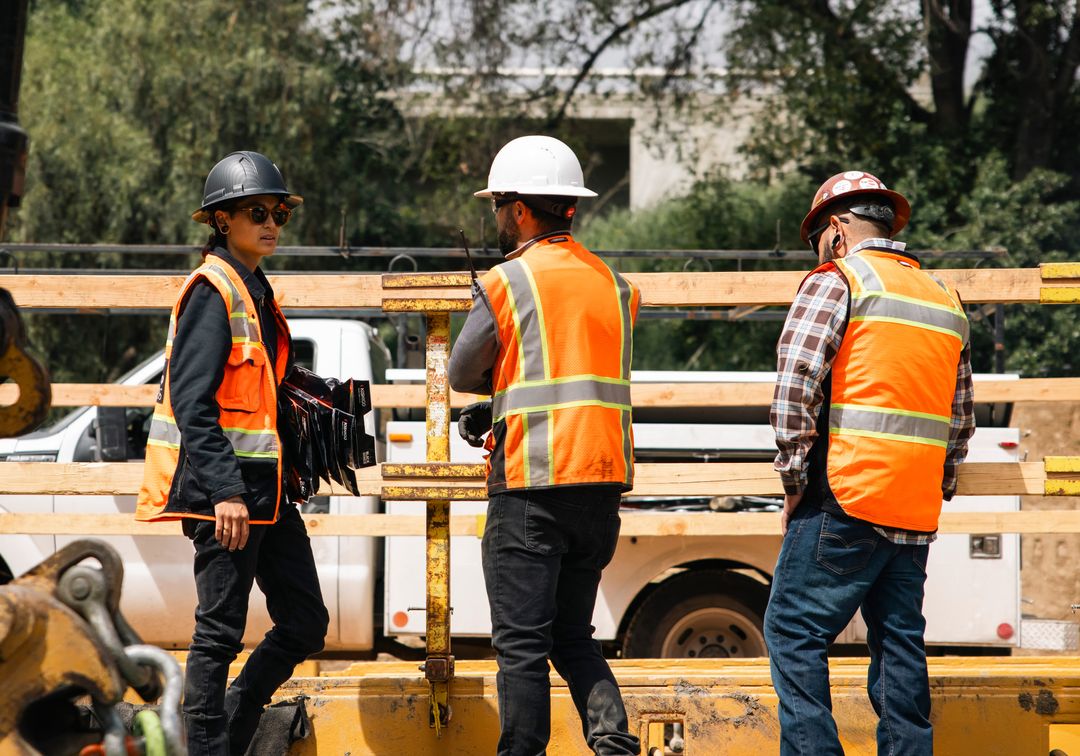 A Phoenix Boring crew in high visibility vests and hard hats at a boring jobsite