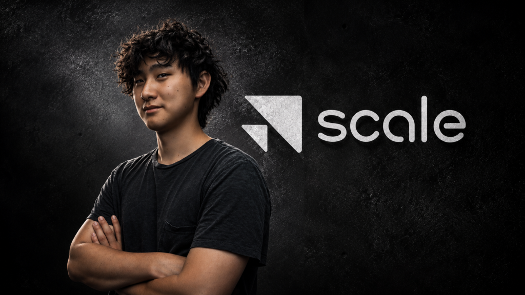 Scale AI Founder Alexandr Wang – Tumisang Bogwasi Portrait of Scale AI founder Alexandr Wang standing with his arms crossed beside the Scale logo against a dark textured background.