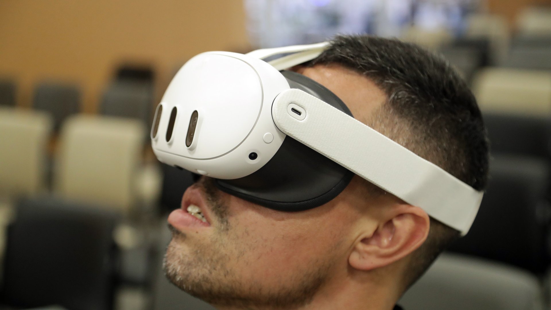 A man wearing a white Meta Quest 3 virtual reality headset